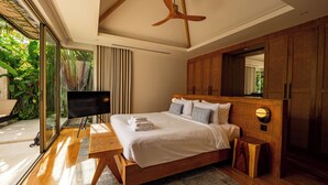 A modern bedroom with a large bed, wooden headboard, and a ceiling fan. - Exclusive villa in Botanica The Nature (Choeng Thale)