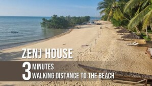 A beach scene with a sign indicating 'ZENJ HOUSE' and a walking distance of '3 MINUTES TO THE BEACH'. - 64 ZENJ HOUSE (Zanzibar Town)