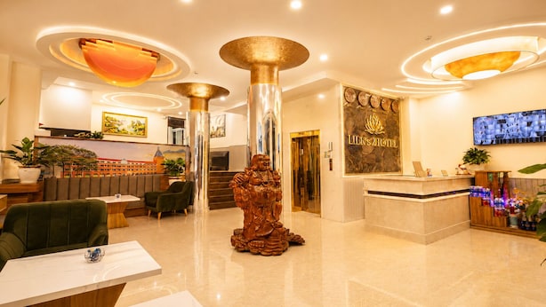 A hotel lobby with a reception desk, seating area, and a statue. - Lien's 2 Hotel Da Lat (Xuan Huong - Da Lat)