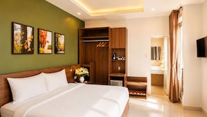 A hotel room with a large bed, a wardrobe, a vanity with a mirror, and a television. - Lien's 2 Hotel Da Lat (Xuan Huong - Da Lat)