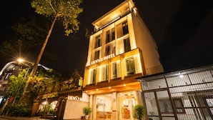 A hotel with a two-story facade, a visible entrance, and a sign indicating it is a hotel. - Lien's 2 Hotel Da Lat (Xuan Huong - Da Lat)