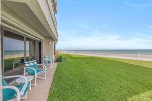 A hotel balcony with a view of the beach and ocean.