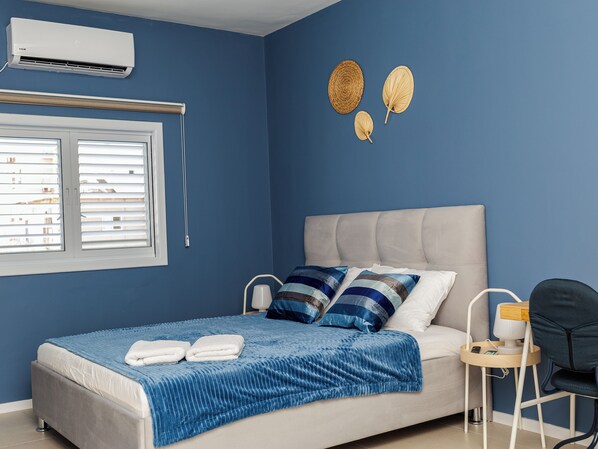 Design Apartment | Desk, laptop workspace, blackout drapes, iron/ironing board