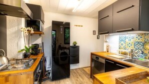 A modern kitchen with wooden countertops, a built-in oven, and a dishwasher.