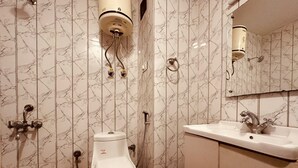 A bathroom with a toilet, a sink, and a shower. - The Kanchanikoot (Manali)