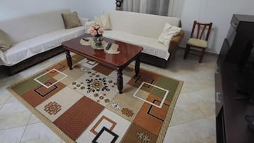 Apartment, 1 Bedroom, Balcony, Hill View | Living area | 32-inch flat-screen TV with cable channels