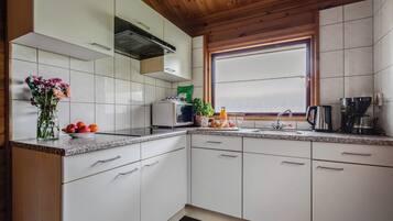 Fridge, stovetop, coffee/tea maker, dining tables