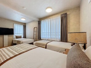 A hotel room with two beds, a TV, a lamp, and a window with curtains. - Viento Ikebukuro (Tokyo)