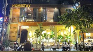 A building with a sign reading "HOMESTAY" and a coffee shop named "MMT Coffee Taste" in front. - MMT Homestay (Can Tho)
