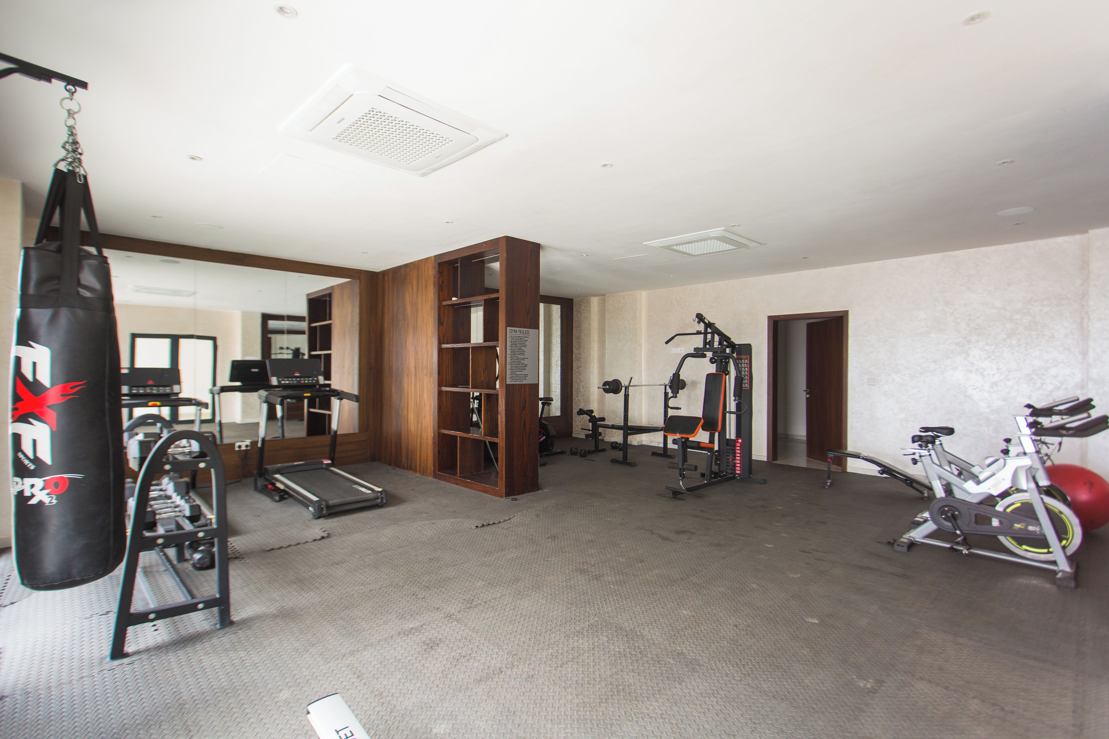 A gym with treadmills, a punching bag, and weightlifting equipment.