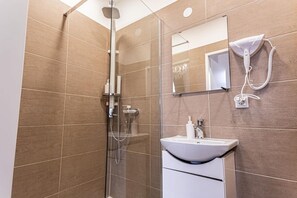 Shower, hair dryer, towels, soap