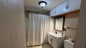 A bathroom with a toilet, sink, and mirror. - 8 beds-Great deal! (Willmar)