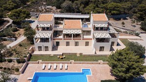 A large, modern villa with a swimming pool, multiple balconies, and a well-maintained garden. - Aphaias Residence Two, Aphaias Villas (Aegina)