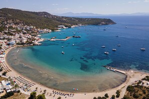 A coastal town with a beach, boats, and a marina.