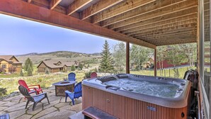 A hot tub under a wooden pergola with a view of a residential area. - Deluxe Granby Ranch Hillside Home: Private Hot Tub (Granby)