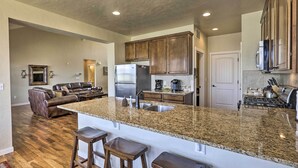 A spacious kitchen with granite countertops, stainless steel appliances, and wooden cabinets. - Deluxe Granby Ranch Hillside Home: Private Hot Tub (Granby)