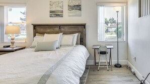A bedroom with a large bed, bedside tables, a chair, and artwork on the wall. - Easy Intl Soccer Stay < 3 Mi to Hard Rock Stadium (Miami Gardens)