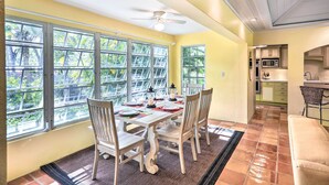 A dining area with a table set for four, large windows, and a view of greenery. - Bright St Thomas Getaway W/pool, 3Mi to Magens Bay (St. Thomas)