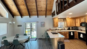 A modern kitchen with wooden cabinets, a granite countertop, and a built-in oven. - Modern and Cozy Cabin w Game Room,  Fireplace and all the amenities in PineTop (Pinetop Country Club)