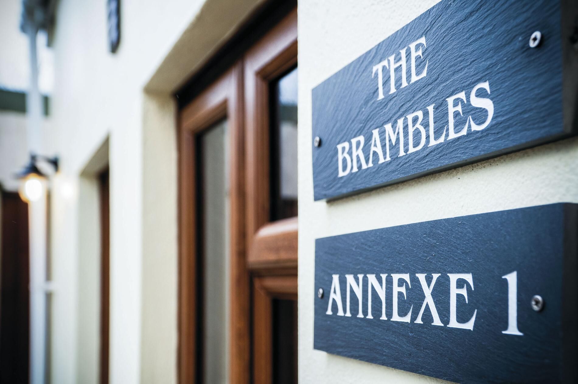 A building with a sign that reads 'The Brambles' and 'Annexe 1'.