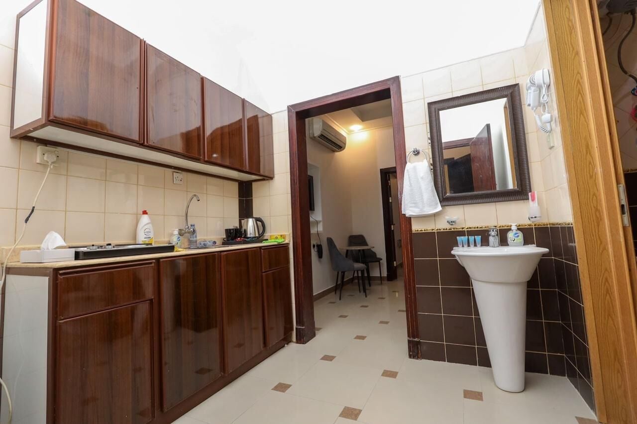 Full-sized fridge, stovetop, cookware/dishes/utensils