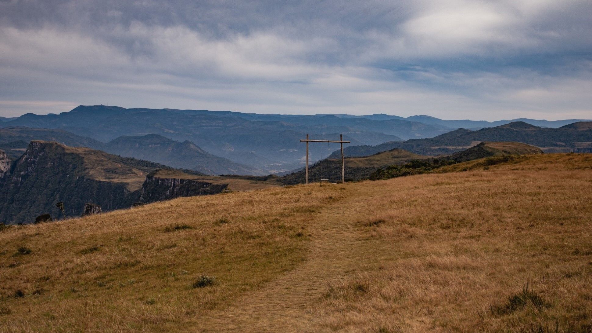 A mountainous landscape with a cross structure in the middle.