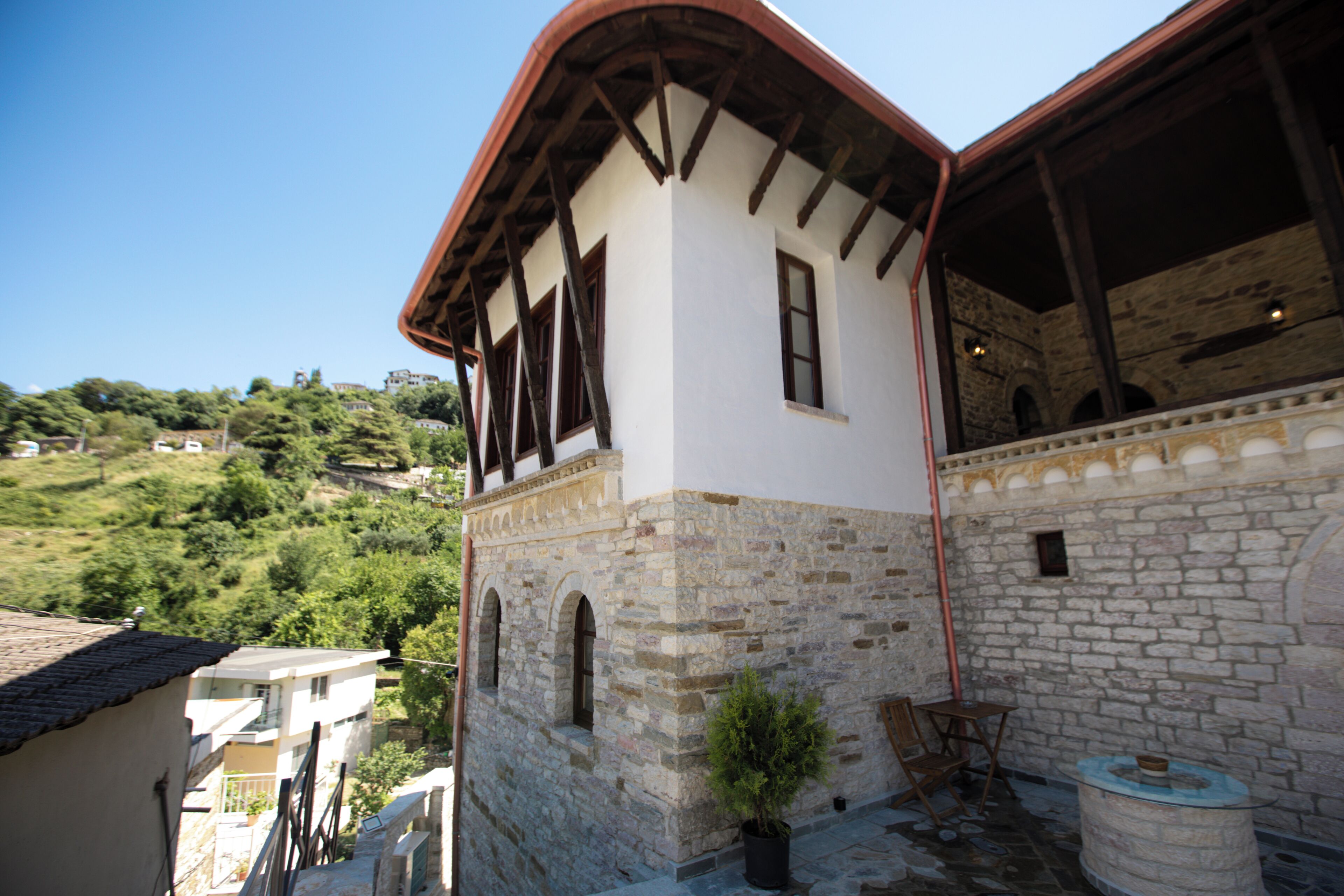 A building with a stone facade, wooden beams, and a sloped roof.