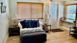 A cozy bedroom with a bed, a bench, and a window with blinds. - Private Delray Beach Pool Home Near Atlantic Avenue, Dining & Beach (Delray Beach)
