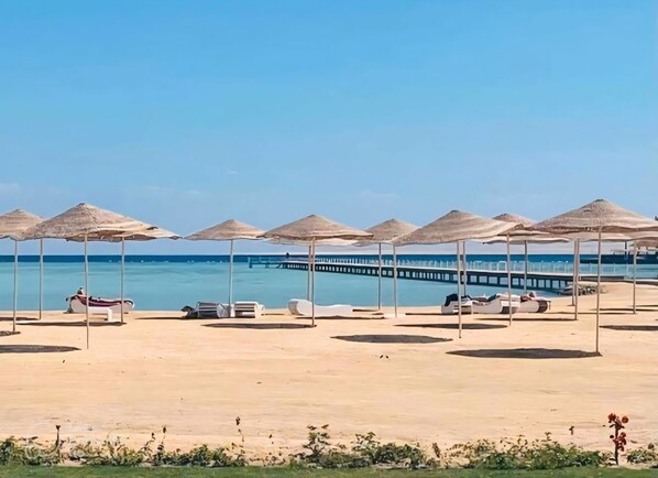 On the beach, sun loungers, beach towels