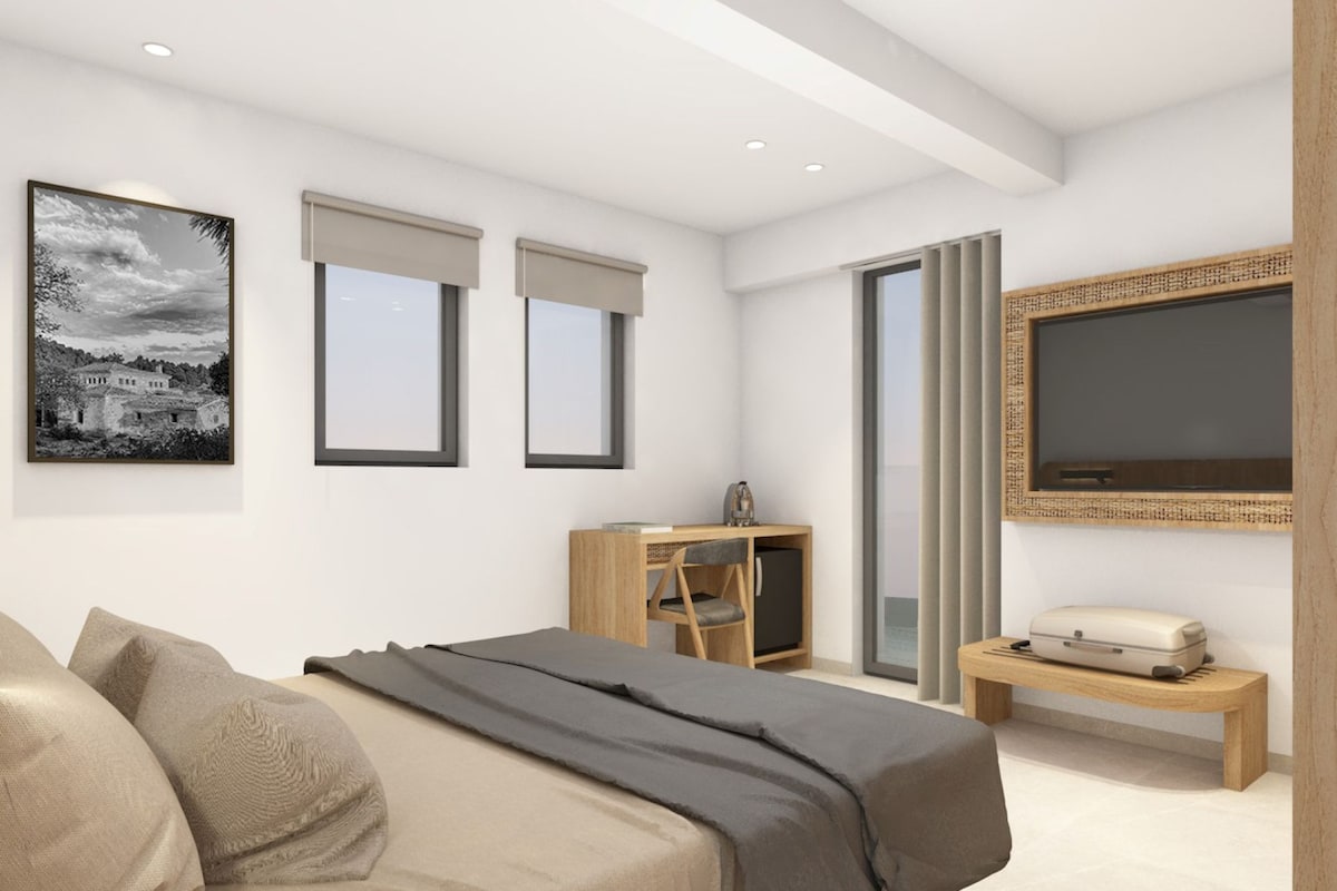 Quarto moderno com cama, escrivaninha, cadeira, televisão e uma janela grande.