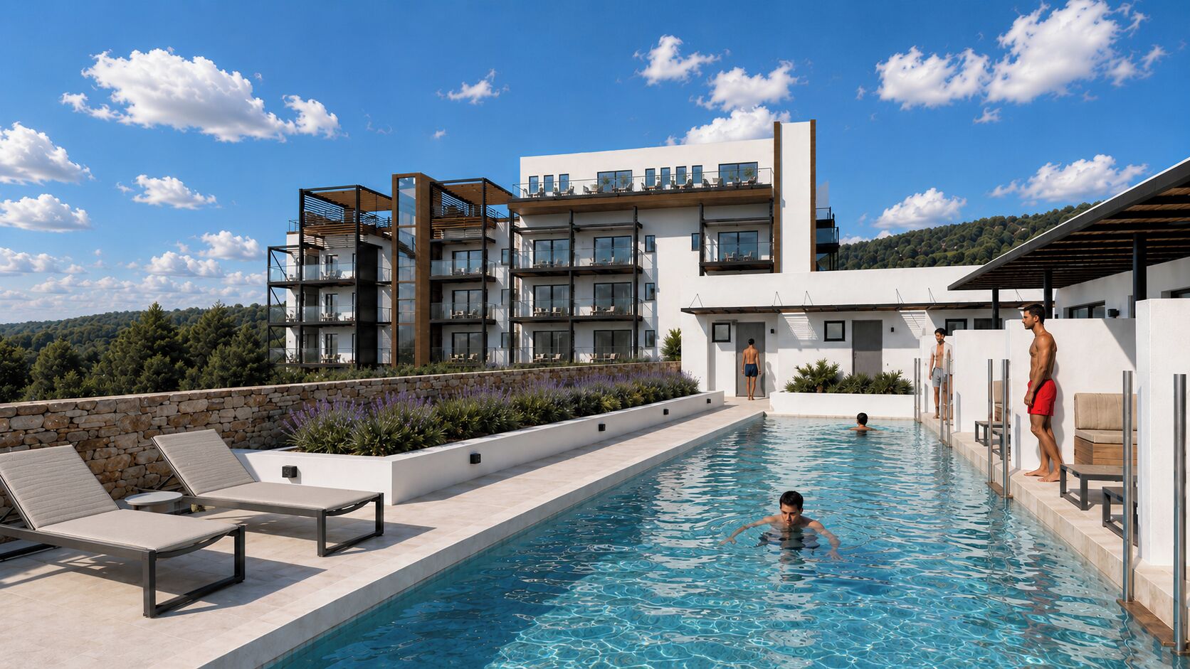 Une piscine avec des chaises longues, un mur en pierre et un bâtiment moderne doté de balcons.