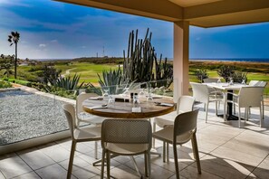 An outdoor dining area with a view of a golf course and ocean. - Tierra del Sol home w/ private pool and BBQ! (Noord)