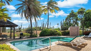 A swimming pool with lounge chairs and a pergola. - Tierra del Sol home w/ private pool and BBQ! (Noord)
