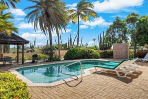 A swimming pool with lounge chairs and a pergola. - Tierra del Sol home w/ private pool and BBQ! (Noord)