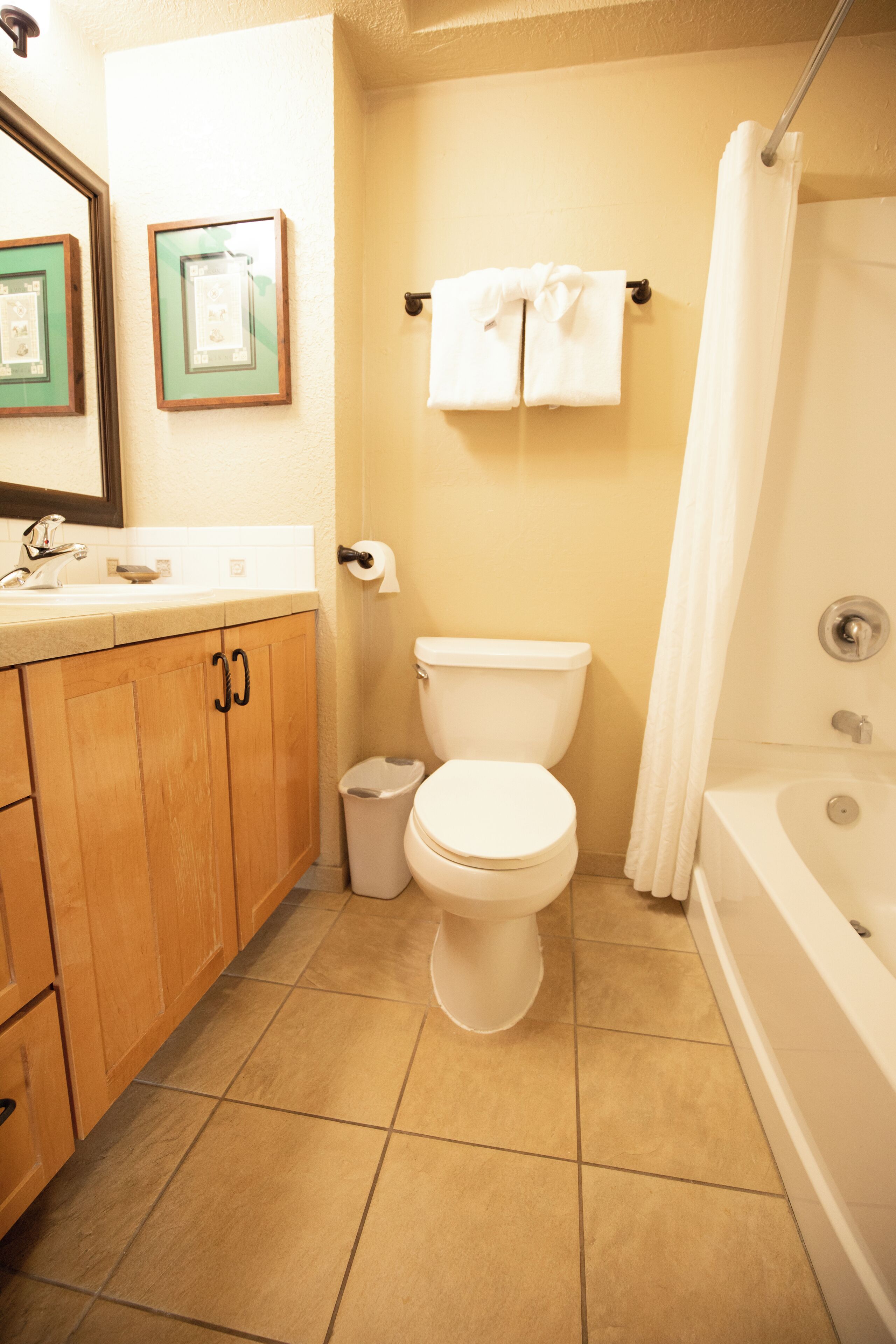 A bathroom with a toilet, sink, and bathtub.