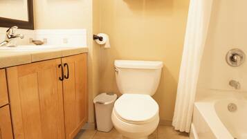 A bathroom with a toilet, sink, and bathtub.