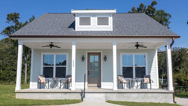 A single-story house with a porch, two windows, and a door. - Lofty Lakeside Cottage – 2 BR, 2.5BA, Sleeps 8! (Greenwood)