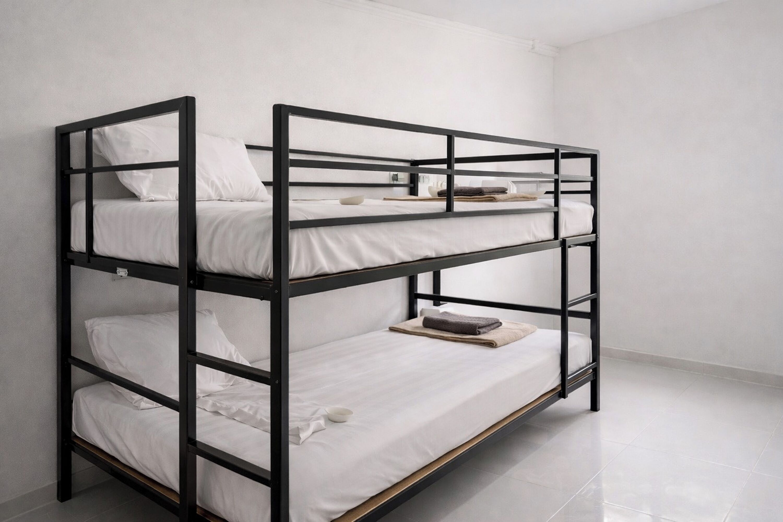 A bunk bed with white bedding and a wooden frame.