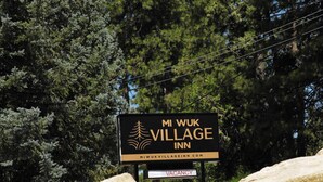 Letrero del Mi Wuk Village Inn con aviso de habitaciones disponibles.