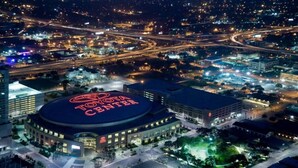 A large, circular building with a prominent Toyota Center sign on top, surrounded by parking areas and connected roads. - Charming 3Bed 2Bath apt in front of NRG & near TMC (Houston)