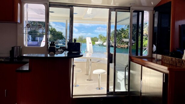 A kitchen with a view of a marina and a pool. - Luxury 47’ Leopard Power Catamaran - Bahamas (Nassau)
