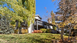 A modern building with a covered outdoor area and a well-maintained lawn.