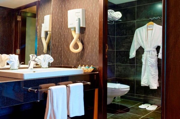 A modern bathroom with a dark wood vanity, a white sink, and a glass shower enclosure. - Nile Cruise Royal Adventure, every Friday from Aswan 3 nights and every Monday from Luxor 4 nights. (Aswan)
