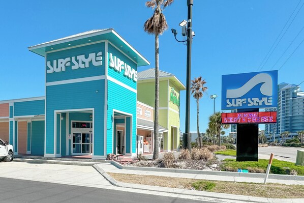 A surf-themed building with a blue facade and a sign that reads "SURFSTYLE."