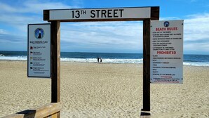A beach sign at 13th Street with beach rules and warning flags. - Oceanview Cottage by Tybee Vacation Rentals (Tybee Island)