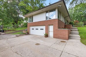 A two-story house with a garage, a front porch, and a brick exterior. - Spacious 4BR Retreat in Rockford (Rockford)
