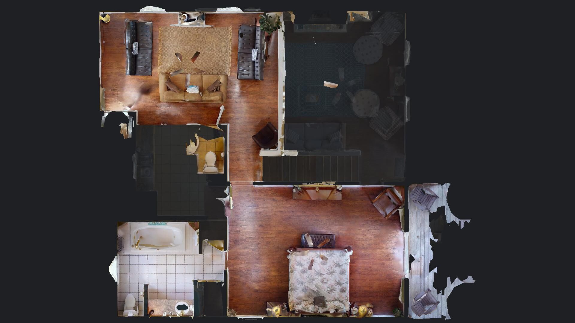 A floor plan of a hotel room with a bed, a small seating area, a bathroom, and a dining area.