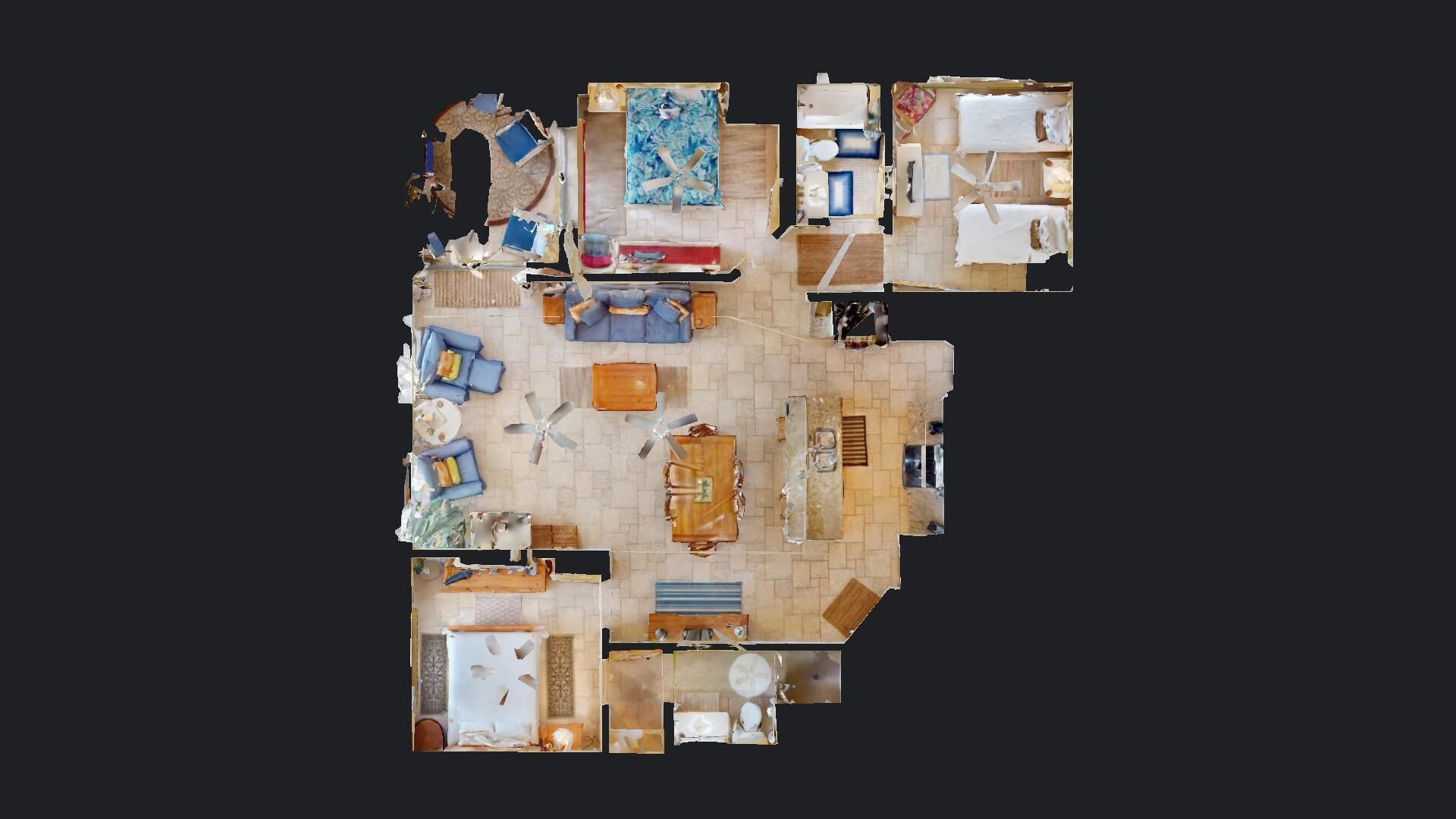 A 360-degree view of a hotel room with a large bed, a sitting area with a sofa and chairs, a dining table, and a small kitchen area.