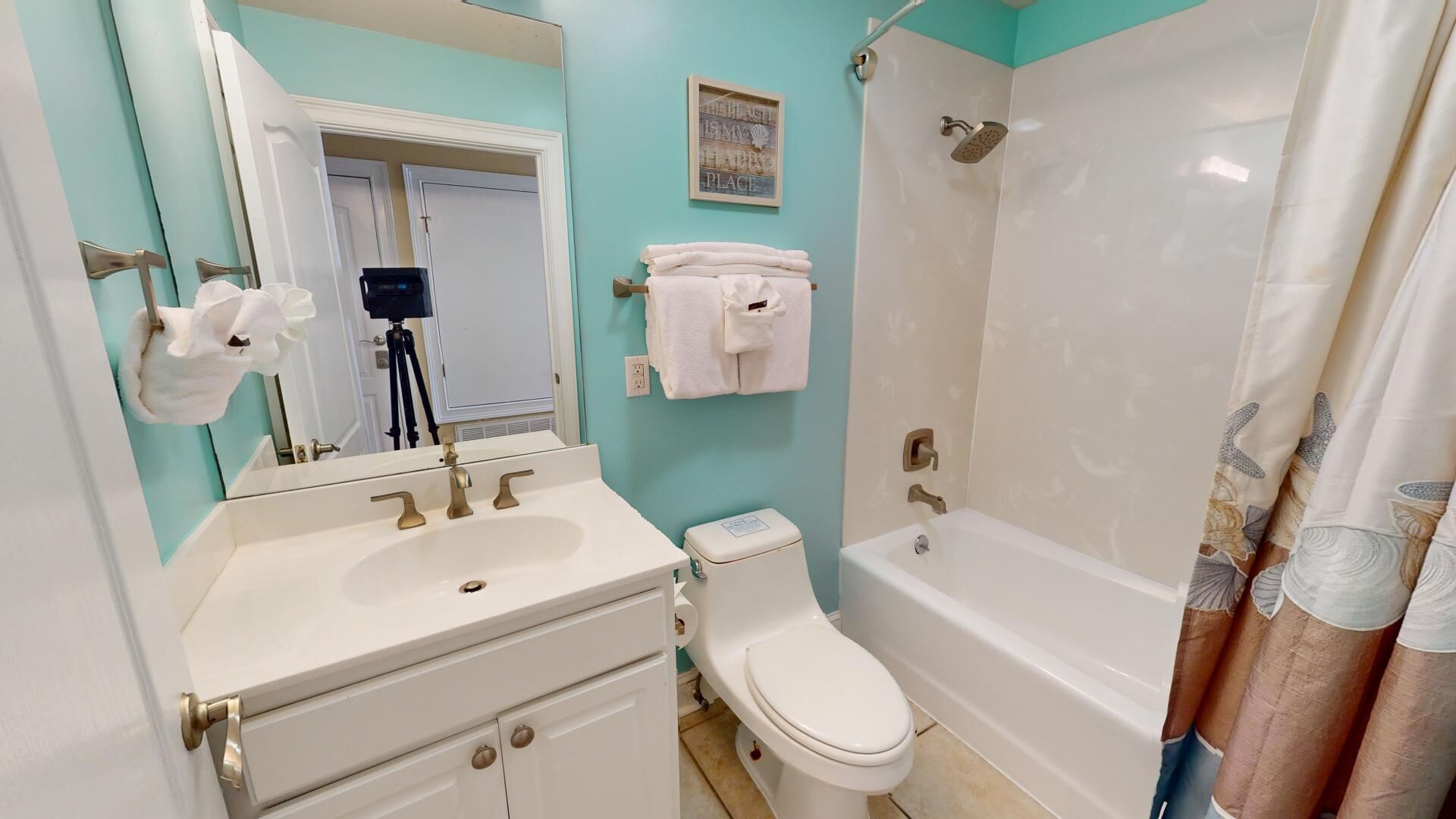 A bathroom with a sink, toilet, and bathtub.