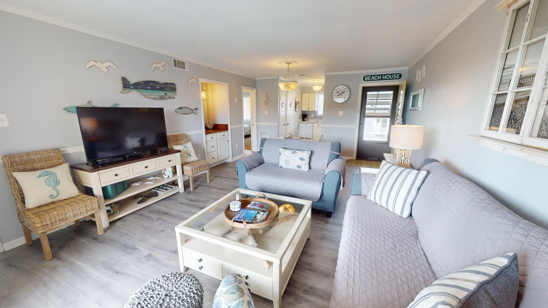 A living room with a television, sofas, and a coffee table.